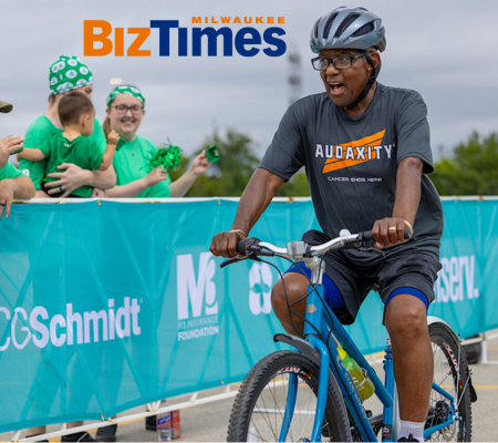 a man cheering as he rides a bike at the Audaxity ride